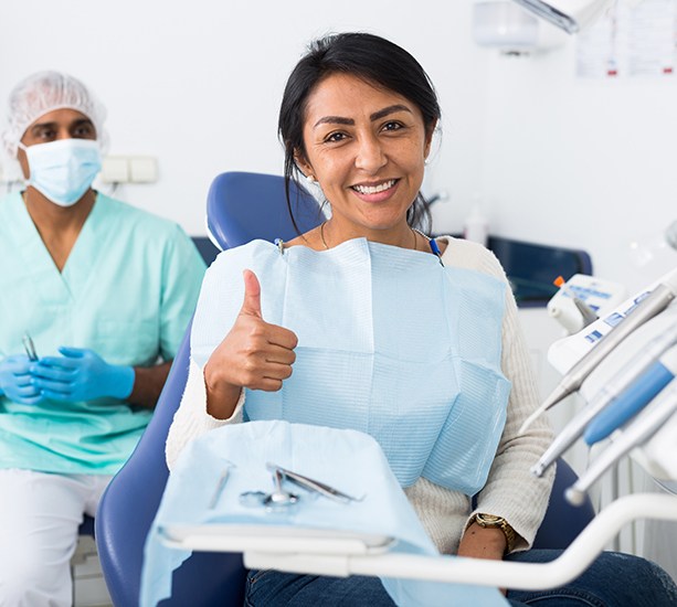 patient smiling with a thumbs up