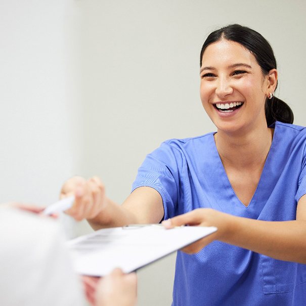 dental team member helping a patient